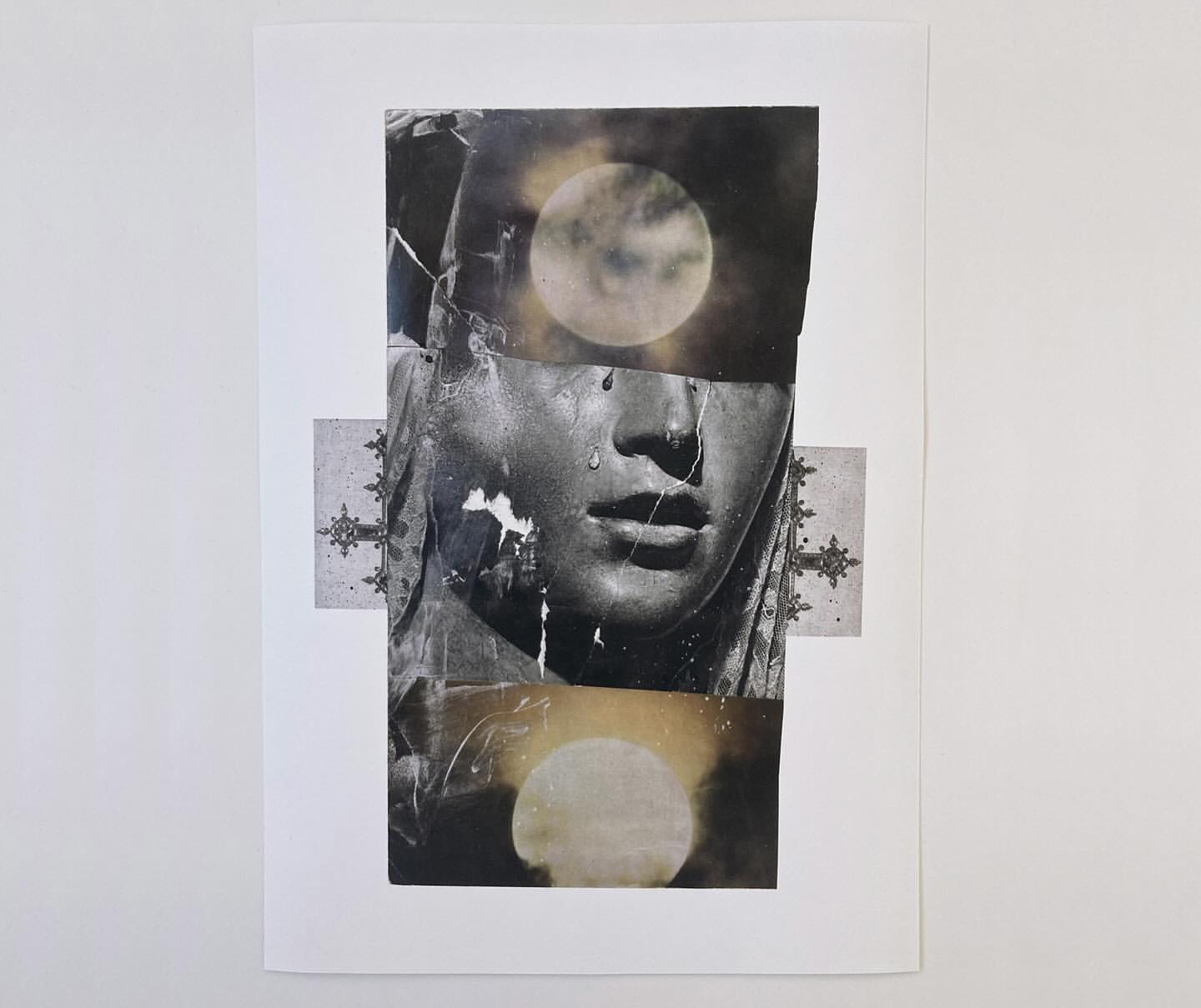 Monochromatic art collage featuring a sculpted face with tears, juxtaposed with an image of the moon and cross designs, on a white backdrop.