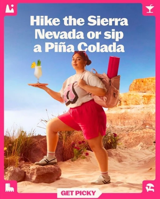 Woman with backpack and Piña Colada strikes hiking pose outdoors in sunny weather. Tourism and beverage advertising concept.