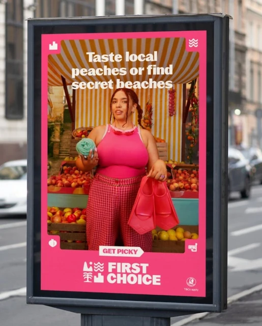 Eye-level shot of an advertisement featuring a woman in front of fruit with beach gear, promoting travel.
