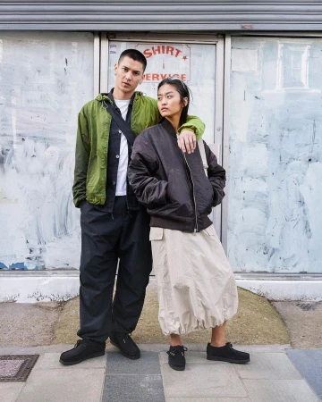 Two models standing on a London street in casual streetwear, photographed by Kaj Jefferies.