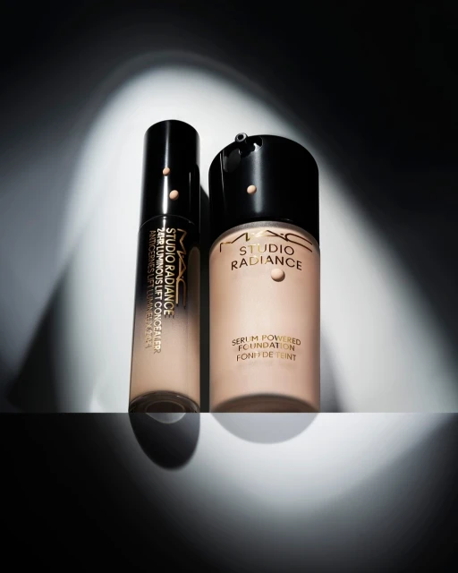Studio shot of MAC Studio Radiance Serum-Powered Foundation and 24HR Luminous Lift Concealer. Beauty and cosmetics product photography.