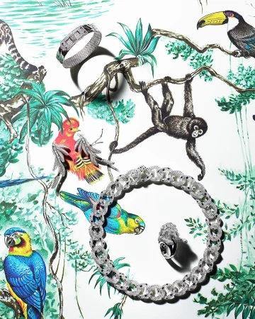 Jewelry set featuring a bracelet, necklace, and ring displayed on a vibrant jungle-themed background with illustrated tropical animals and foliage.