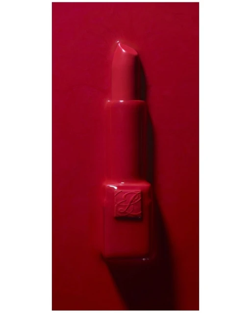 Close-up of red lipstick on a red background, showcasing a smooth texture and vibrant color for beauty and cosmetic marketing.