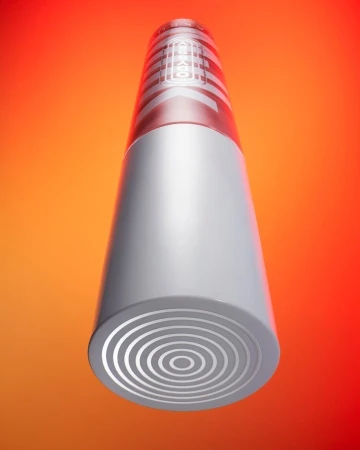 Elevated product shot of a gray, cylindrical container with concentric circles and geometric patterns against a gradient red and orange backdrop.