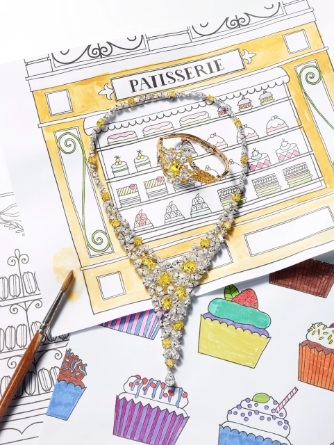 Elegant yellow diamond necklace and ring displayed on an illustrated background of a patisserie and cupcakes. Jewelry product shot.