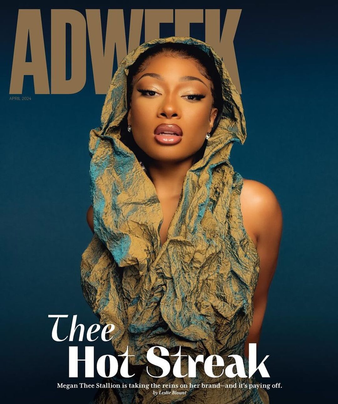 Adweek magazine cover featuring an adult female with fair skin, wearing a draped gold and teal textured garment against a teal background.