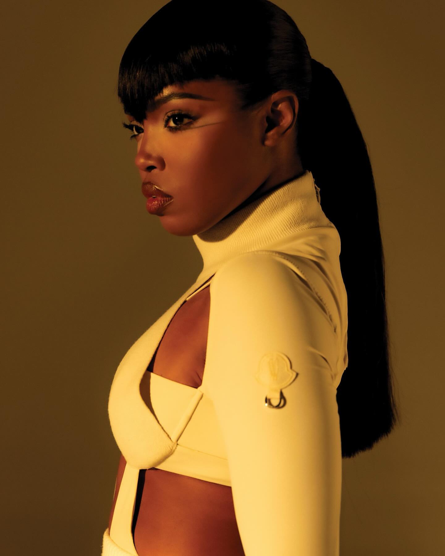 Side-profile shot of a Black woman with a ponytail and bangs, wearing a light-yellow cut-out top, against a yellow background.