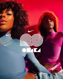 Two models wearing athletic mock neck tops against a vibrant pink background with graphic text elements