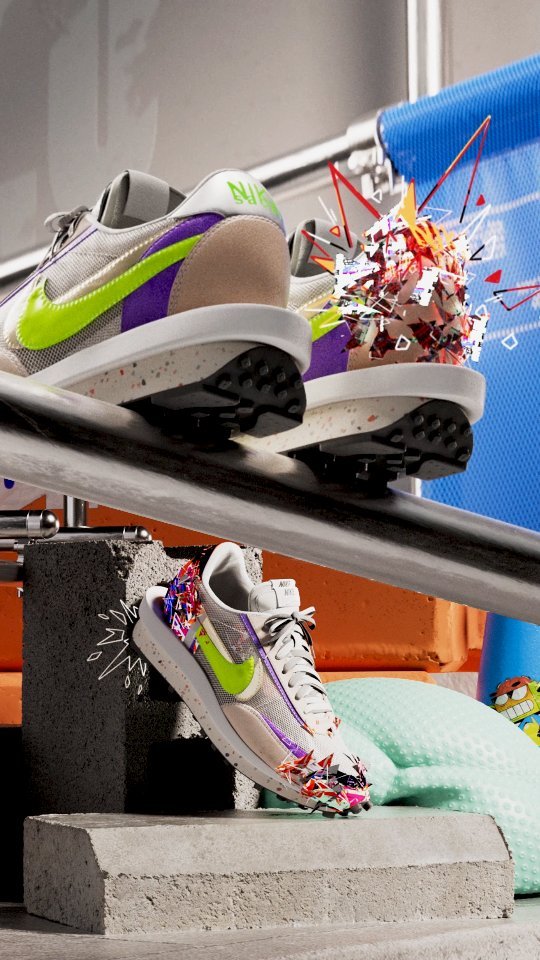 Two Nike sneakers are creatively displayed on stacked concrete blocks and metal bars against a white and grey backdrop with colorful accents.