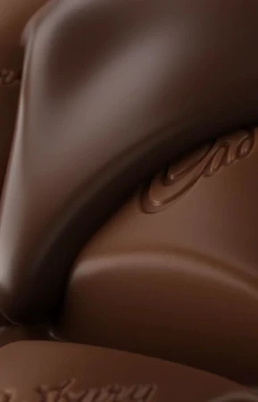 Close-up of light brown chocolate with cacao logo embossed on the surface, showing its smooth texture and rich color.
