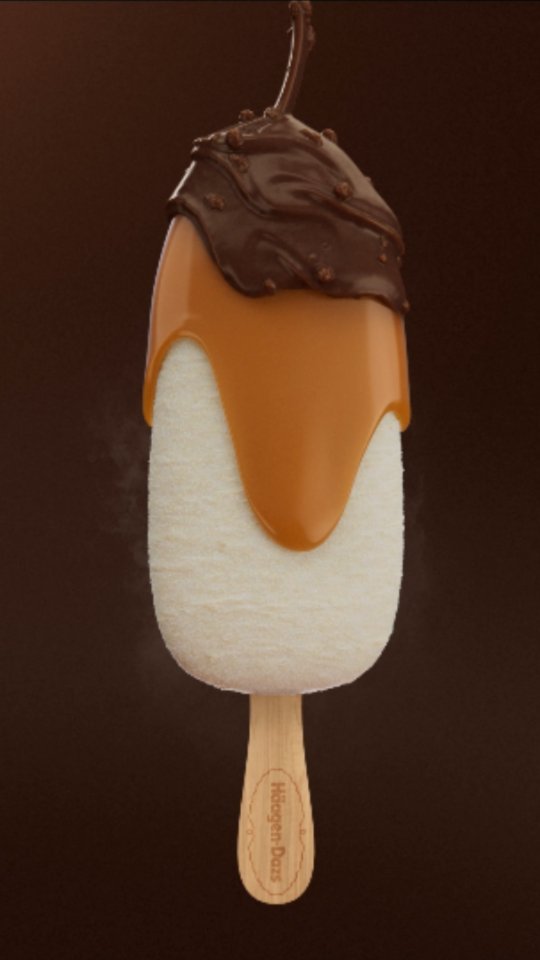 An ice cream bar with a caramel and chocolate drizzle on a brown background, showcasing food photography for Haagen-Dazs.