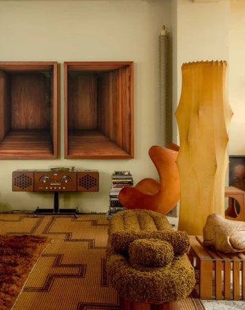 Eclectic living room with a unique chair, vintage radio, and framed artwork, capturing an artistic and retro interior design.