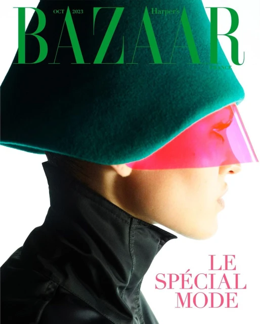 Bazaar cover featuring a fashion model in a green hat with a pink visor, striking a pose against a clean white backdrop.