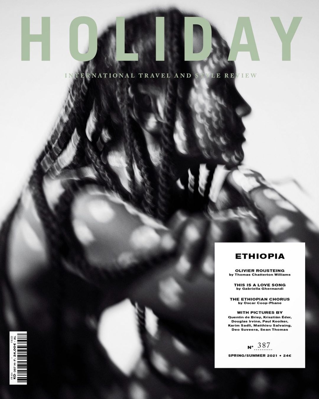 Holiday magazine cover featuring a Black model with braided hair and an abstract background. The focus is on travel and style.