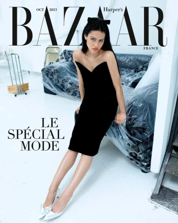 Fashion magazine cover featuring a woman in a black dress and bow, sitting in a studio with Bazaar and Harper's Bazaar text.
