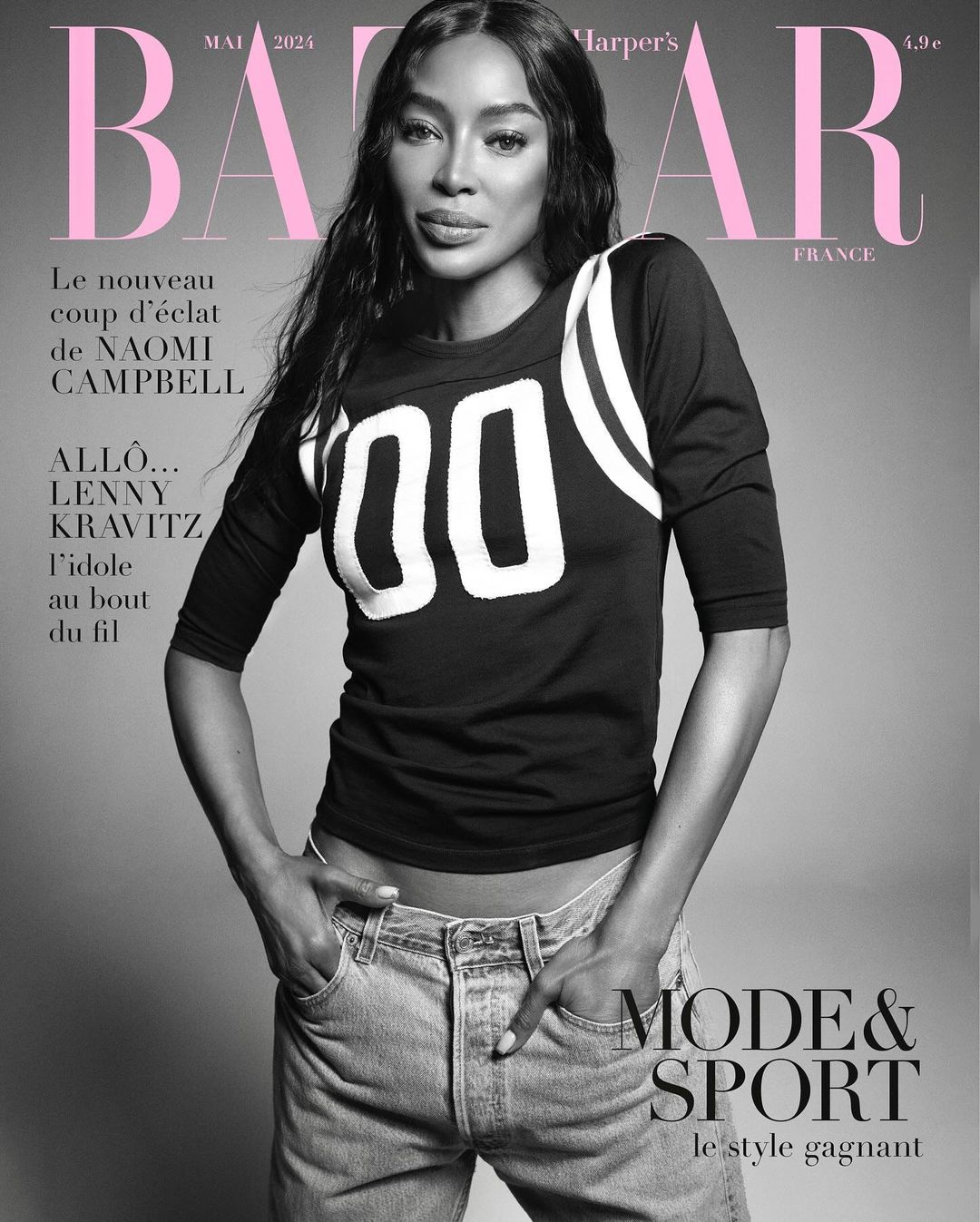 Naomi Campbell graces Harper's Bazaar France cover in May 2024, wearing a black sport jersey and blue jeans against a grey backdrop.