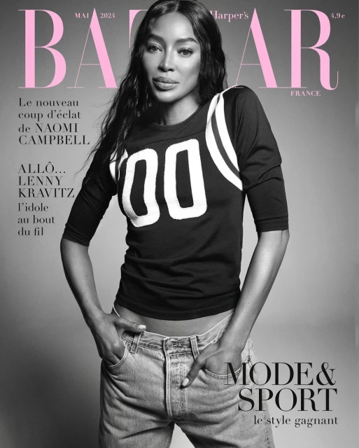 Naomi Campbell graces Harper's Bazaar France cover in May 2024, wearing a black sport jersey and blue jeans against a grey backdrop.
