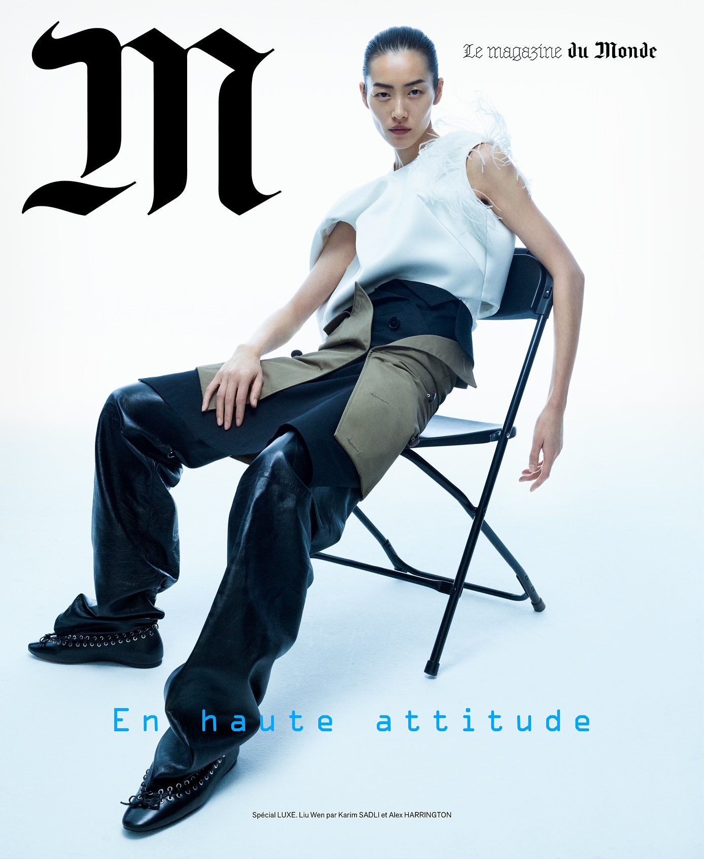 Magazine cover featuring an Asian female model in a white top and black pants sitting on a black folding chair against a white backdrop.