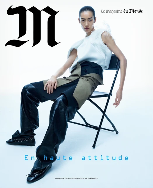 Magazine cover featuring an Asian female model in a white top and black pants sitting on a black folding chair against a white backdrop.