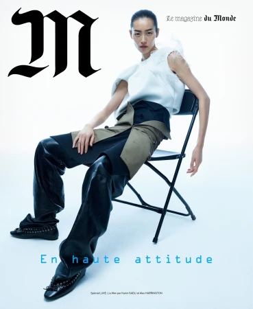Magazine cover featuring an Asian female model in a white top and black pants sitting on a black folding chair against a white backdrop.