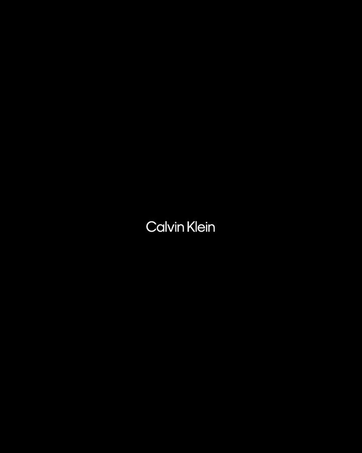 Calvin Klein brand advertisement featuring a minimalist design with the logo displayed against a dark background, showcasing the brand.