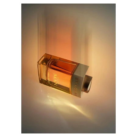BVLGARI MAN Terrae Essence amber fragrance: transparent glass bottle with amber liquid at a diagonal against a white surface.