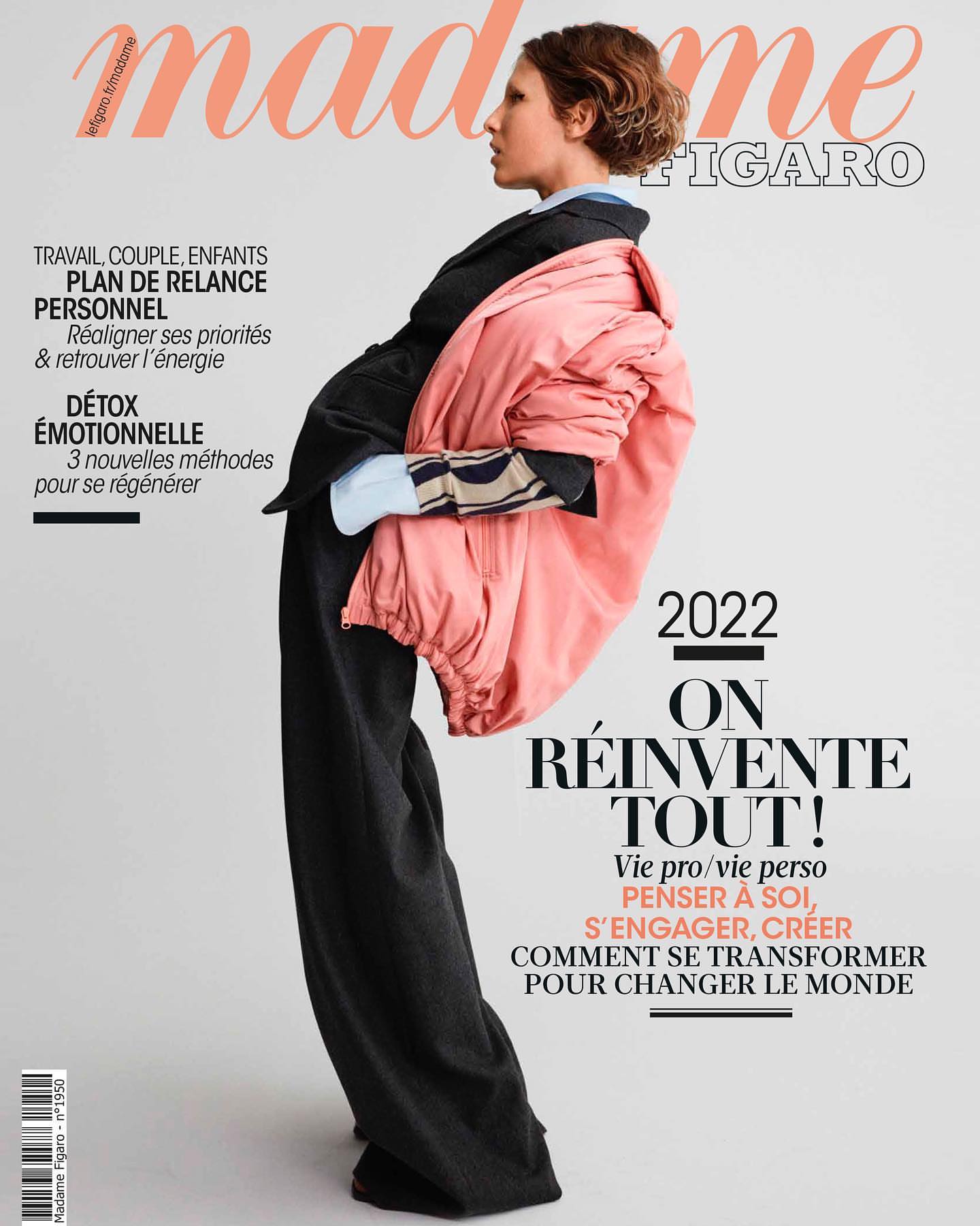 Magazine cover featuring a young woman in a black suit with a pink coat draped over her shoulder, alongside bold magazine text.