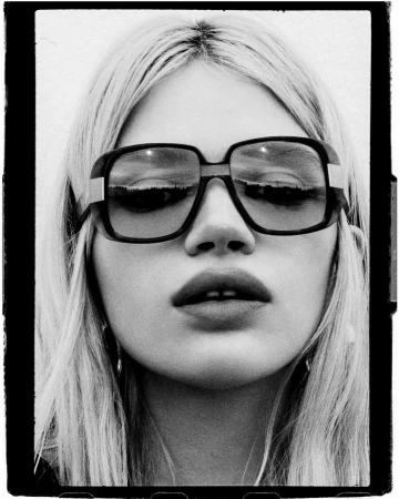 Close-up black and white portrait of a blonde woman wearing large sunglasses by photographer Kate Bellm.