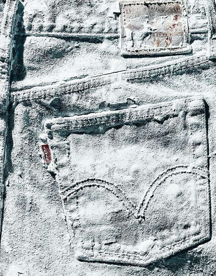 Close-up of vintage denim jeans coated in a white powder, showcasing texture and weathered details. Fashion, textile, still life.