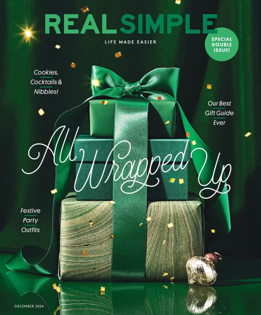 Stacked gift boxes wrapped with green ribbons on a magazine cover. Festive holiday theme with sparkling confetti against a dark green backdrop.