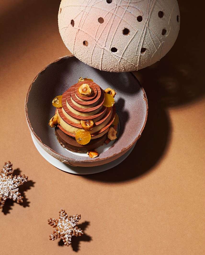 Elegant dessert in a bowl with snowflake cookies on a brown surface, showcasing culinary artistry and festive confectionery.