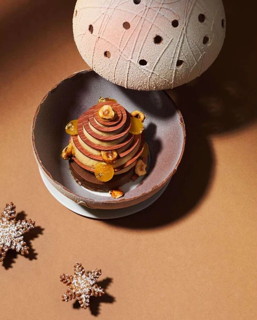 Elegant dessert in a bowl with snowflake cookies on a brown surface, showcasing culinary artistry and festive confectionery.
