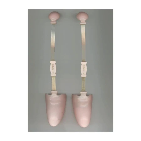 Pair of pink shoe stretchers on a grey background, showing the knob handles, tension rods, and shoe-shaped forms.