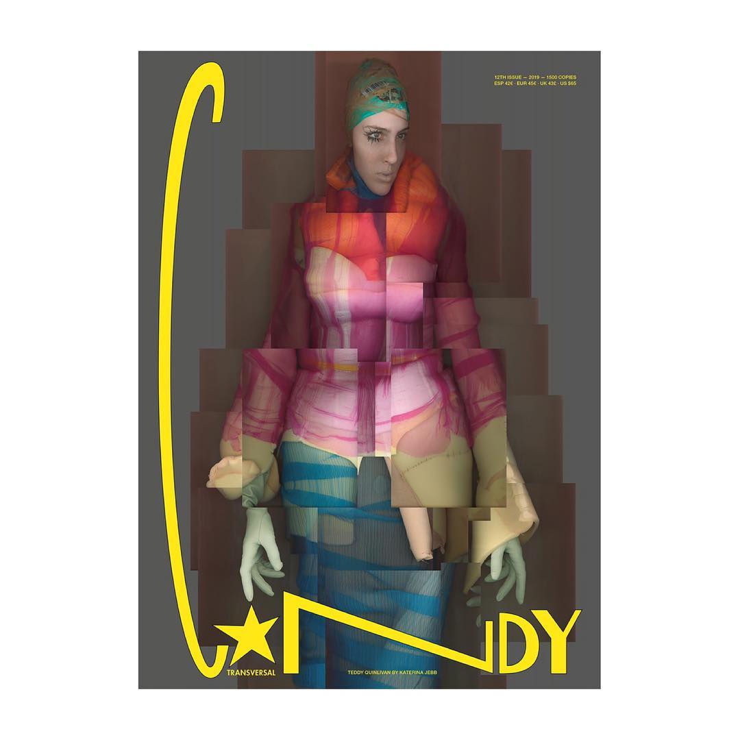 Magazine cover featuring a model in a colorful outfit, presented with a pixelated glitch effect against a grey background with yellow text.