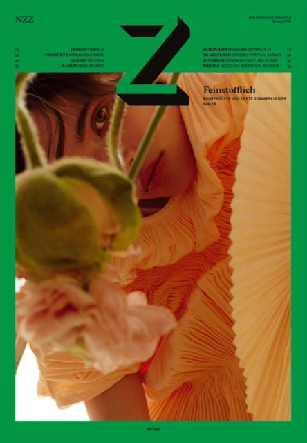 NZ Zeitschrift fur Schweizerische Style magazine cover featuring a woman's face partially obscured by flowers and draped in orange fabric.