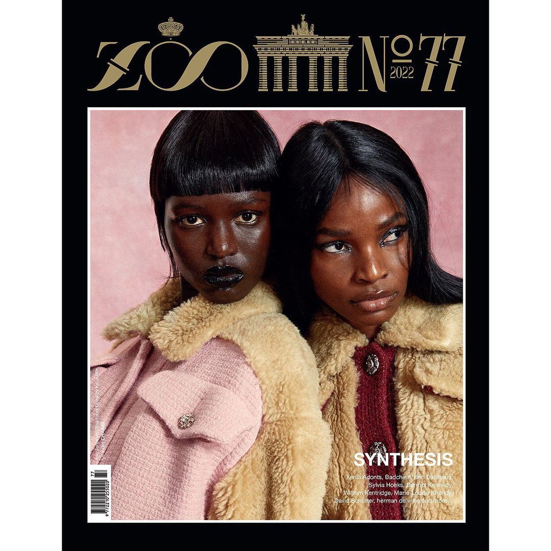 Magazine cover featuring two adult females, showcasing fashion and beauty against a light pink backdrop with black and gold text details.