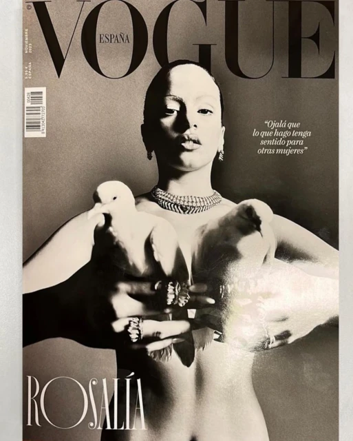 Vogue España cover featuring Rosalía holding two white doves, adorned with jewelry, in a black-and-white photograph with magazine text.