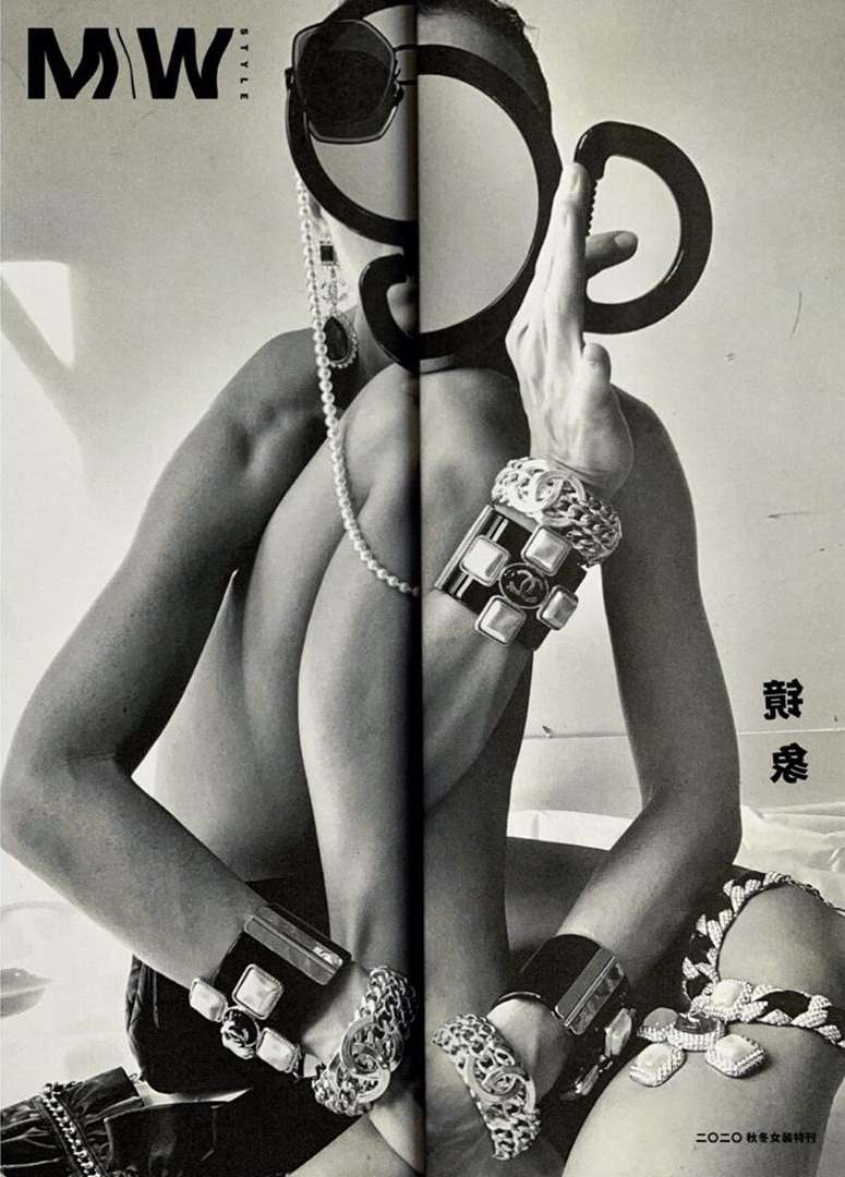 Black-and-white fashion shot in magazine: a model poses with jewelry, sunglasses, and striking shadow play, creating an edgy, unique visual.