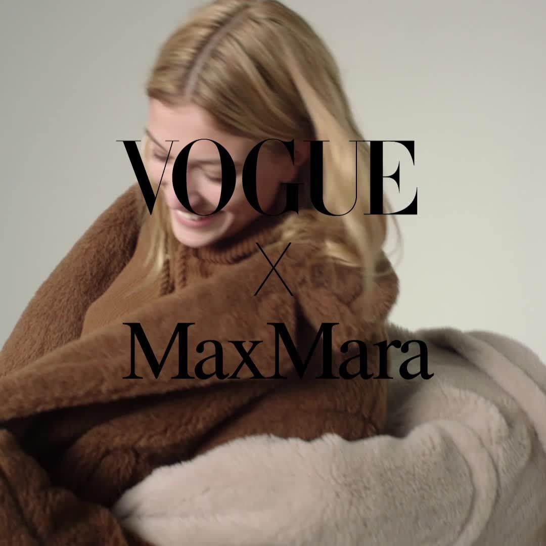 Blonde woman in a brown furry hooded sweatshirt in front of a beige backdrop, featuring overlaid black Vogue x Max Mara text.