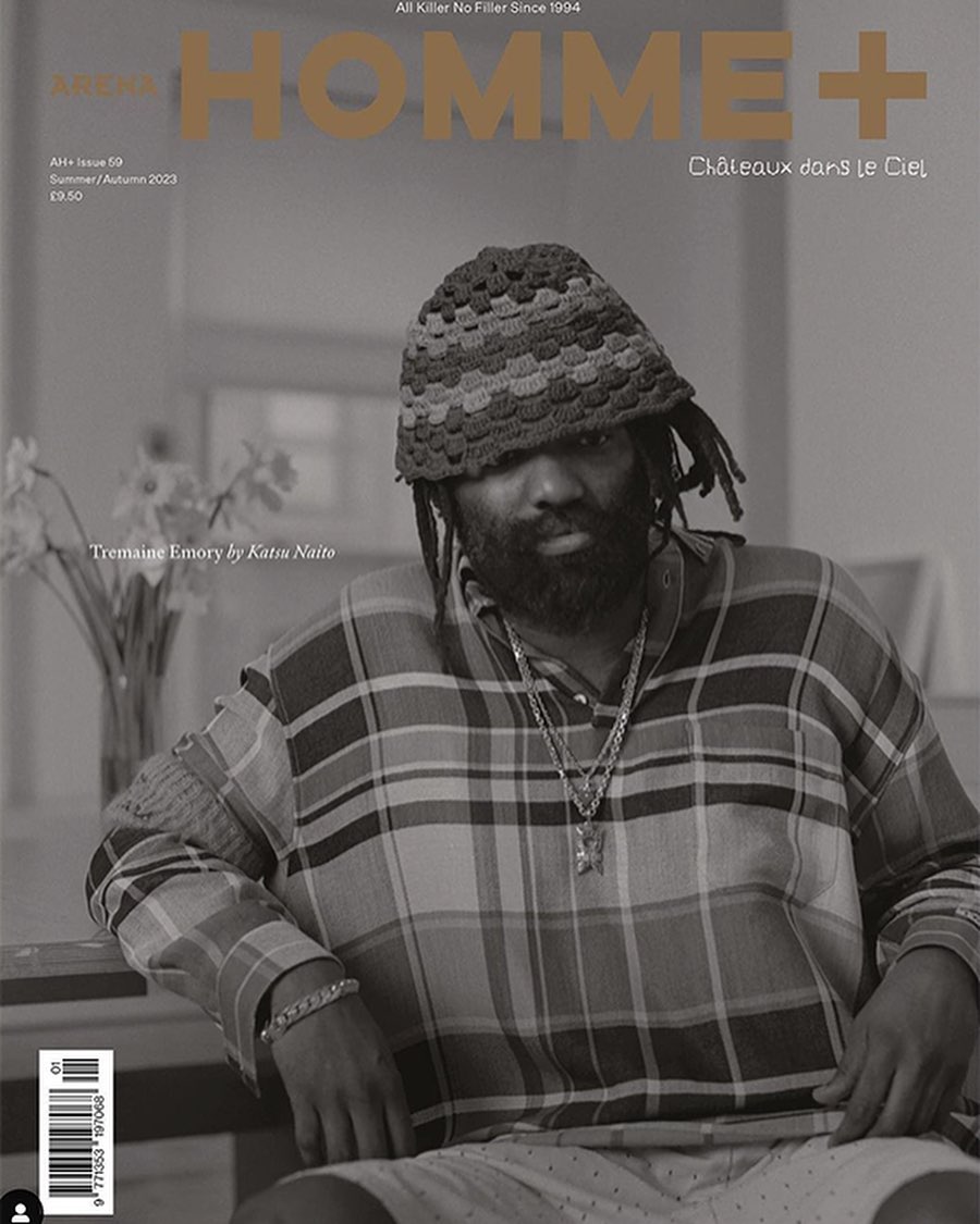 Magazine cover featuring a portrait of a bearded man with dreadlocks wearing a crocheted hat and patterned shirt in a muted color palette.