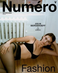 Model Julia Bergshoeff reclining on wooden floor in black underwear and sheer tights, photographed by Kay Nambiar