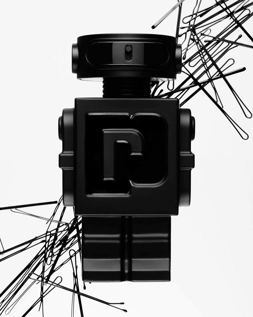 Black robot figure surrounded by hairpins on a white background, studio lighting, artful product shot.