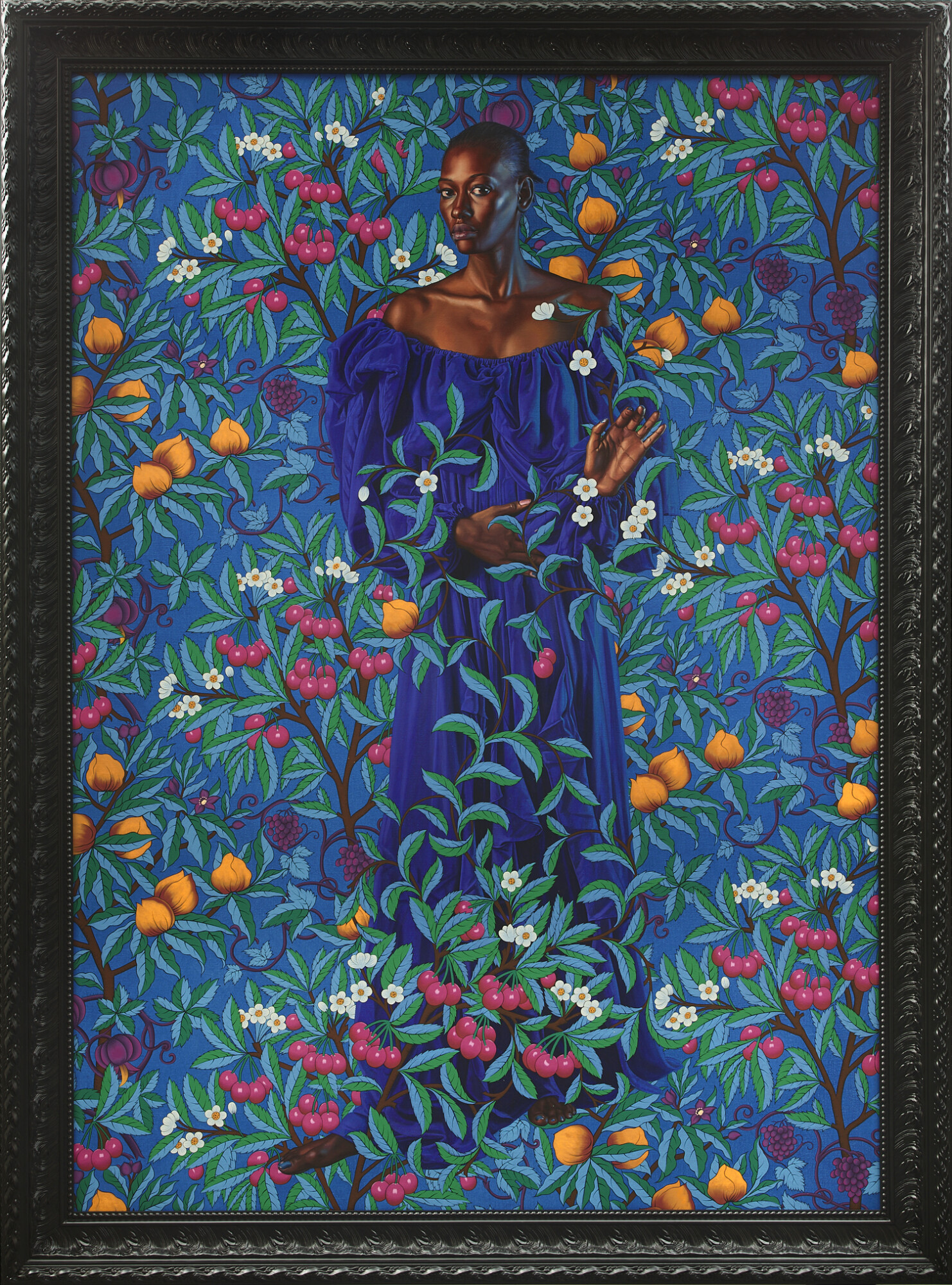A framed portrait painting features a bald black female in a blue dress, standing against a vivid blue backdrop of fruit and foliage.