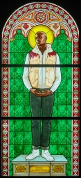Stained glass window by Kehinde Wiley depicting a black man with a halo wearing a puffer vest, hoodie, and jeans.
