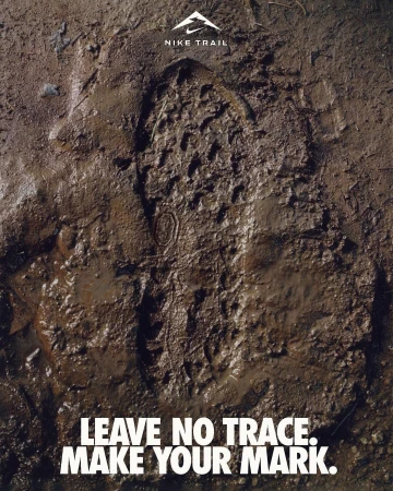 Footprint imprinted on mud, promoting Nike Trail with the slogan 'Leave No Trace. Make Your Mark.' focused on outdoor running.