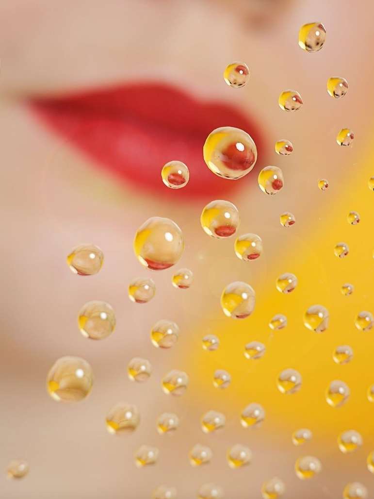 Macro shot of water droplets reflecting light and forming patterns against a blurred background with red lips in soft focus.