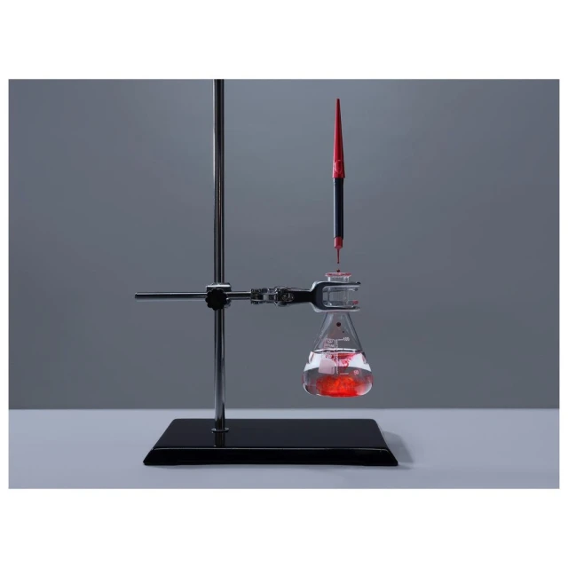 Close-up of a laboratory setup with a flask containing a red liquid being filled by a pipette, showcasing chemistry or science concept.