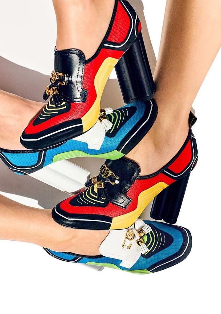 Fashionable shoes with block heels are piled together, showcasing a colourful contemporary design with black, red, blue, and yellow accents.