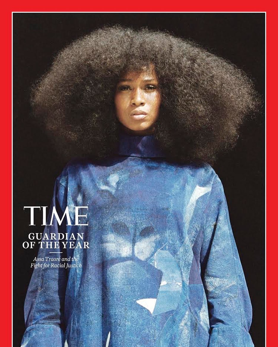 Time magazine cover featuring a portrait of a woman with large afro hair, wearing a blue patterned top, against a dark background.