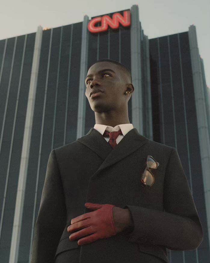 Stylish black male model in a dark suit with a red glove, posing in front of the CNN building, creating a formal and powerful aesthetic.